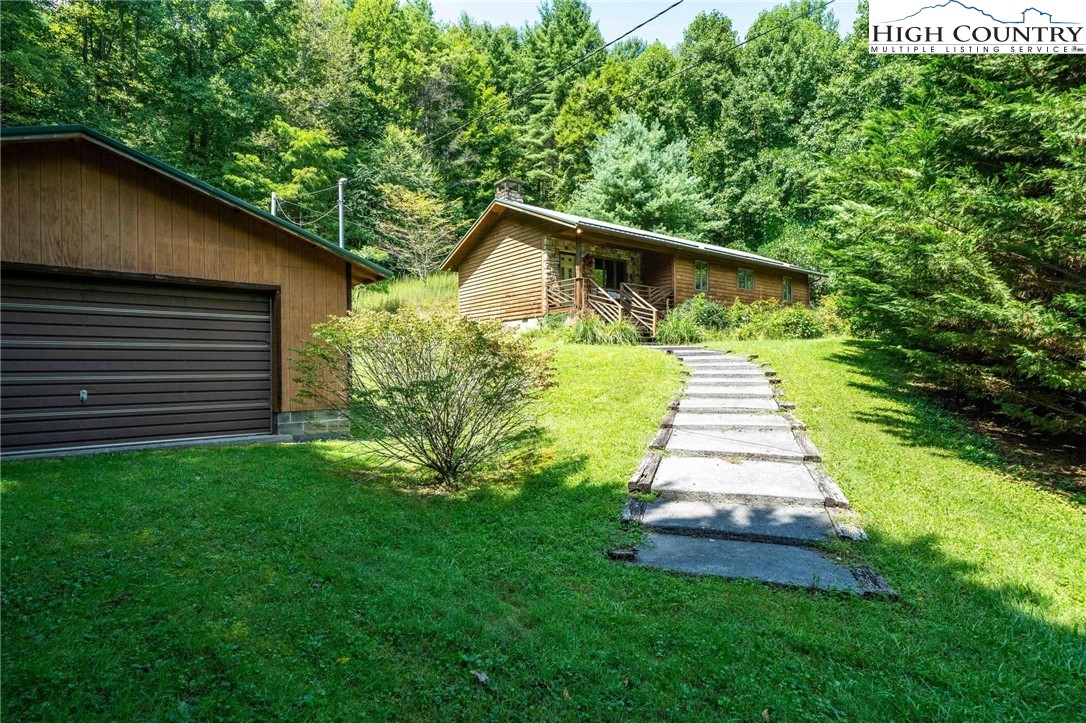 424 Poga Road Butler, TN 37640 - Photo 5 of 40 a front view of a house with a yard and trees