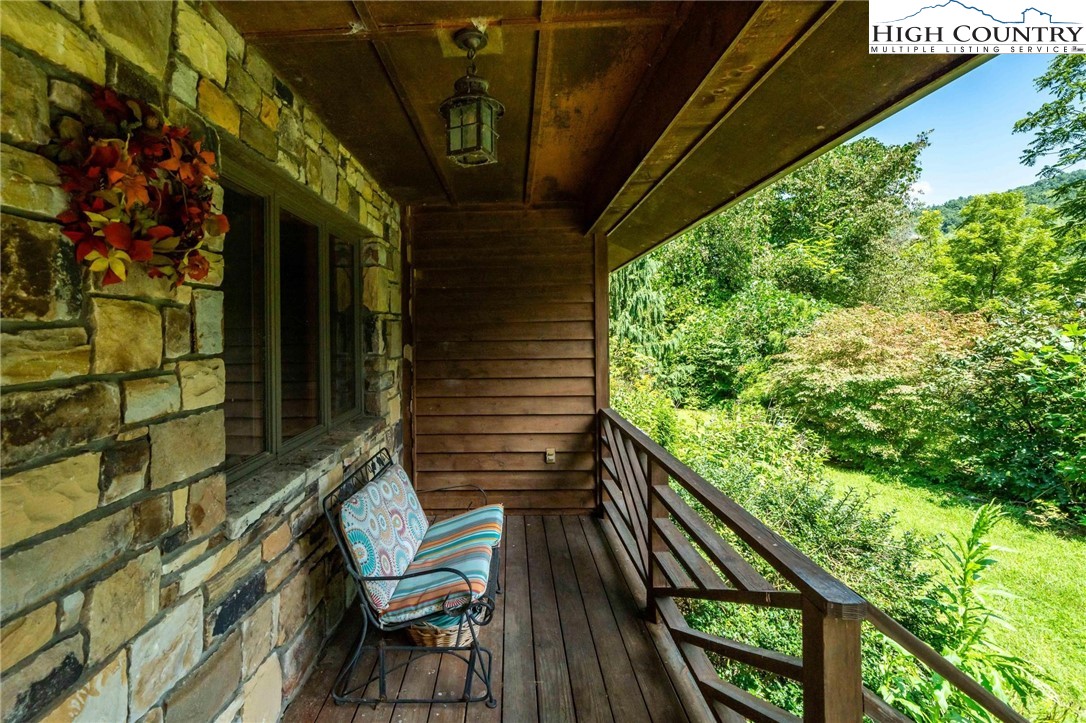 424 Poga Road Butler, TN 37640 - Photo 7 of 40 a view of balcony with wooden floor and outdoor seating