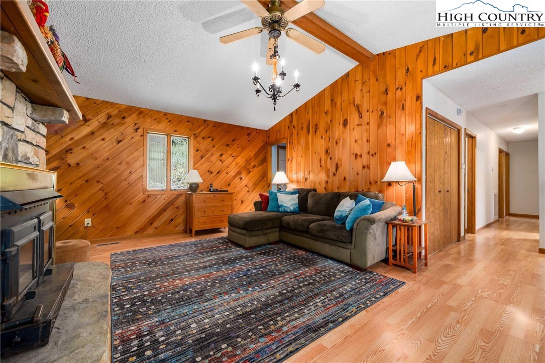 424 Poga Road Butler, TN 37640 - Photo 10 of 40 a living room with furniture a fireplace and a chandelier