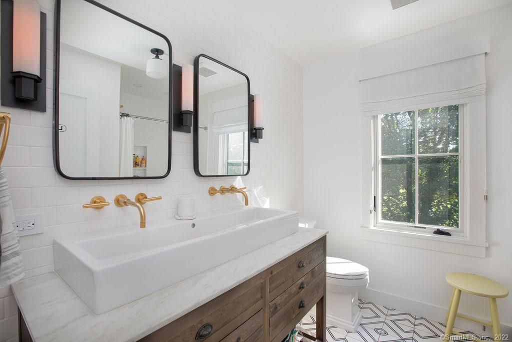 49 Benton Hill Road Sharon, CT 06069 - Photo 11 of 21 a bathroom with a sink and a mirror with toilet