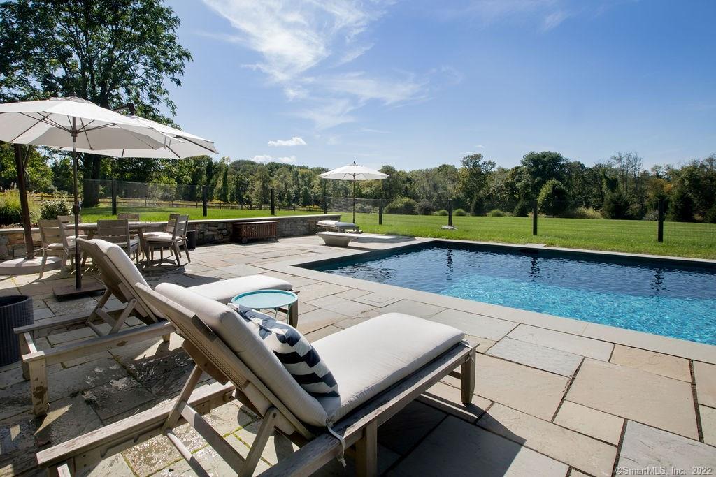 49 Benton Hill Road Sharon, CT 06069 - Photo 12 of 21 an outdoor sitting area with furniture and umbrella