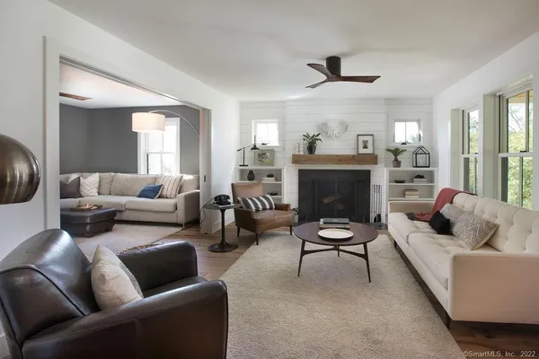 a living room with furniture and a fireplace