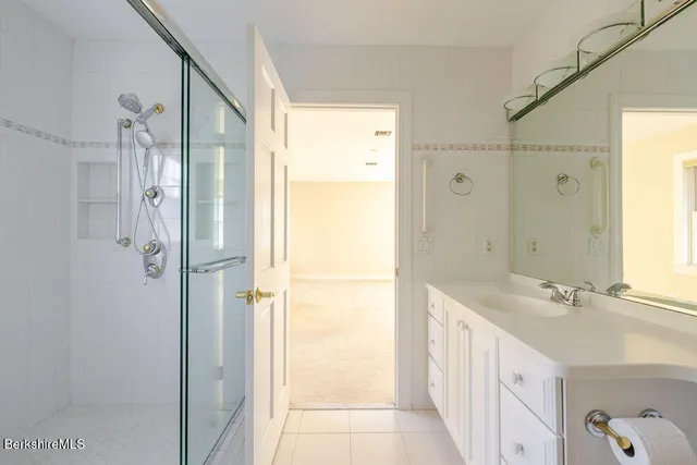 a bathroom with a double vanity sink and a shower