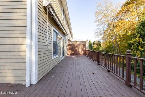 a view of a balcony with wooden floor