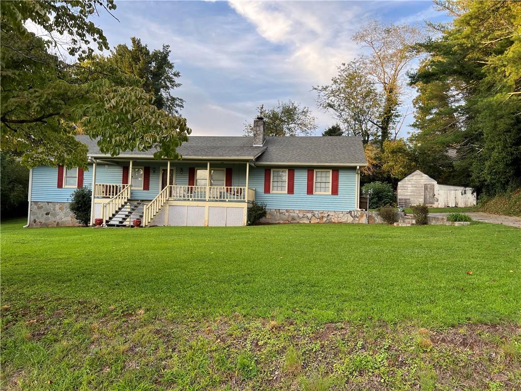a front view of a house with a yard and green space