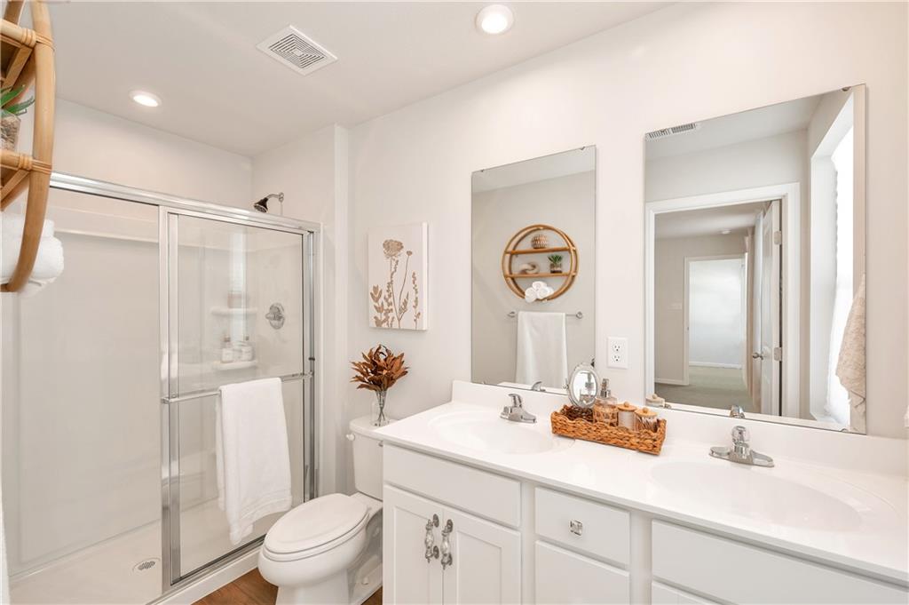 105 Jerome Drive Butler, PA 16001 - Photo 22 of 35 a bathroom with a sink a toilet and a large mirror