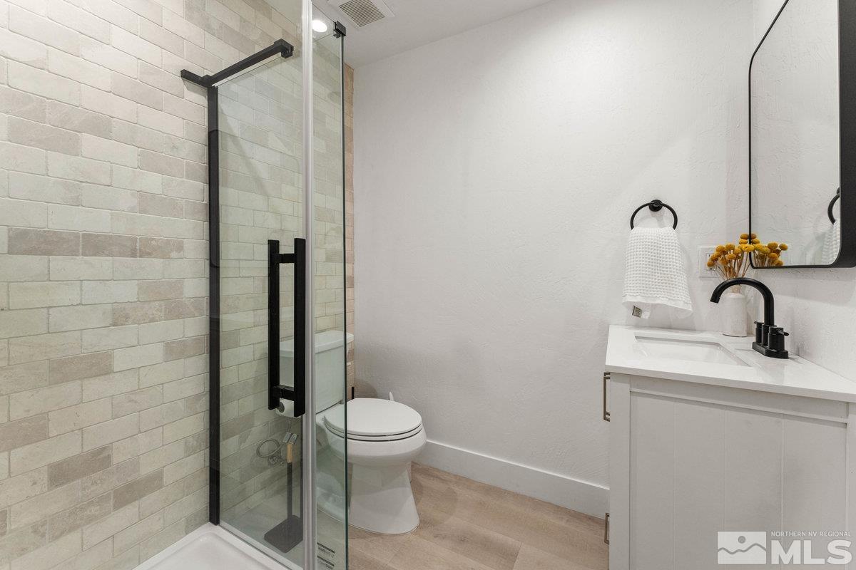 215 Neilson Road Reno, NV 89521 - Photo 12 of 40 a bathroom with a toilet a sink and shower