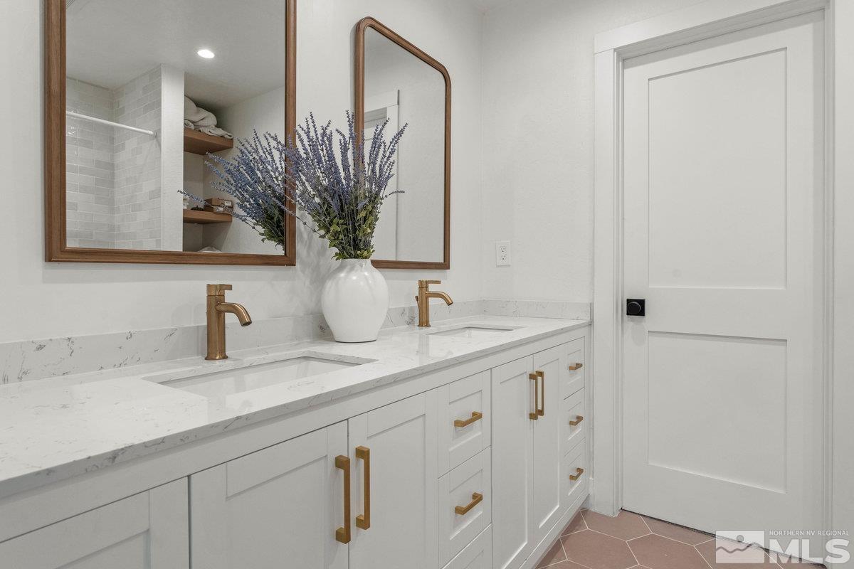215 Neilson Road Reno, NV 89521 - Photo 16 of 40 a bathroom with a granite countertop sink a mirror and a shower
