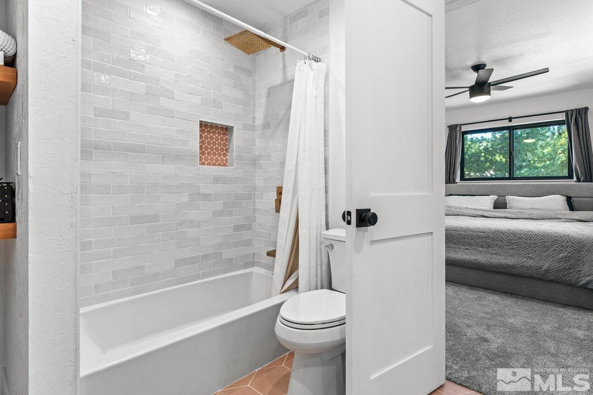215 Neilson Road Reno, NV 89521 - Photo 17 of 40 a bathroom with a white bath tub a toilet and a shower
