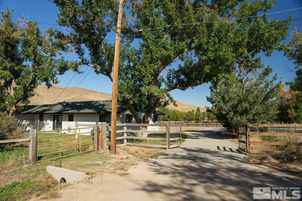 215 Neilson Road Reno, NV 89521 - Photo 24 of 40 a view of a house with large trees