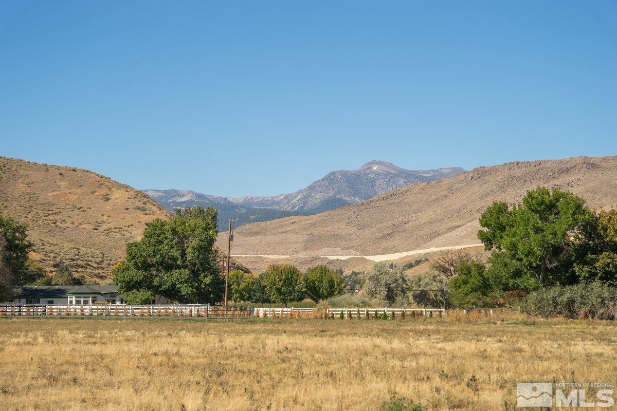 215 Neilson Road Reno, NV 89521 - Photo 34 of 40 a view of a house with a mountain and a forest