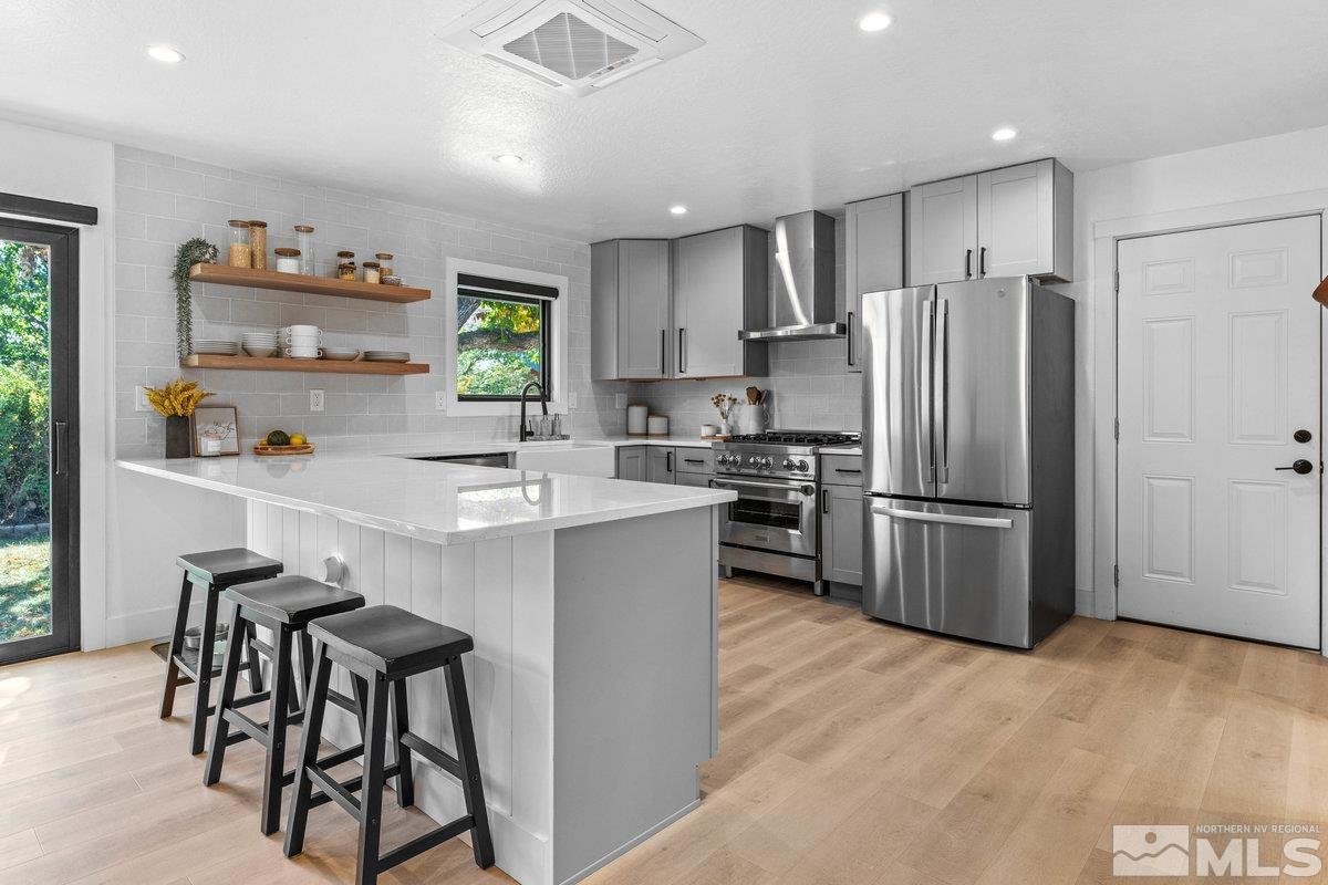 215 Neilson Road Reno, NV 89521 - Photo 9 of 40 a kitchen with stainless steel appliances a refrigerator and a stove top oven