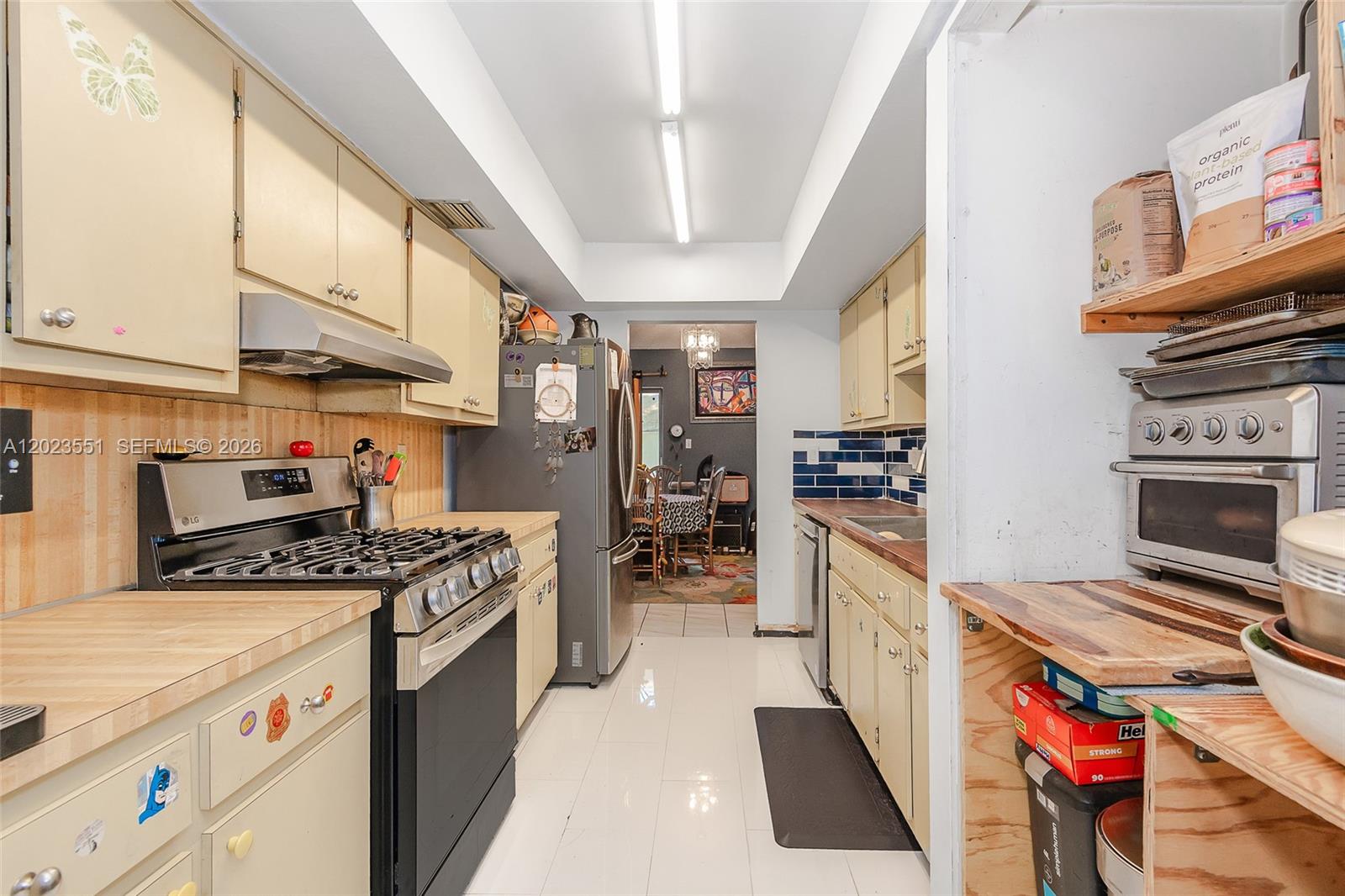 11482 Southwest 109th Road, Unit 29A Miami, FL 33176 - Photo 8 of 28 a kitchen with stainless steel appliances granite countertop a stove and a refrigerator