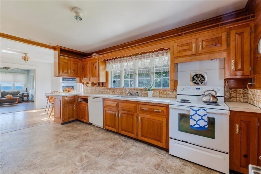 70 Hedge Road Plymouth, MA 02360 - Photo 19 of 41 a kitchen with granite countertop a sink stove and cabinets