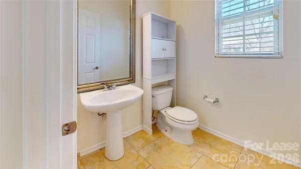 a bathroom with a sink toilet and a mirror