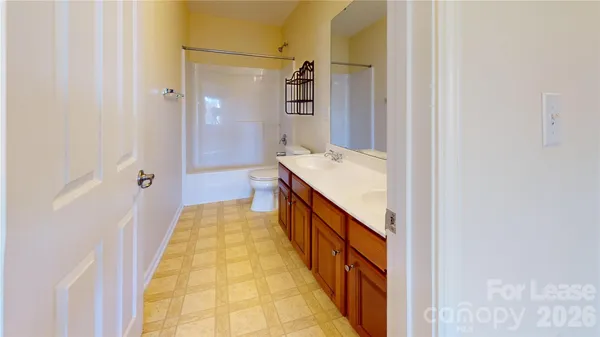 a bathroom with a double vanity sink and mirror