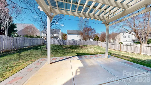 a view of a house with backyard and tree s