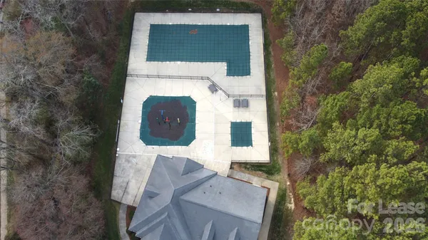 aerial view of a house with a yard