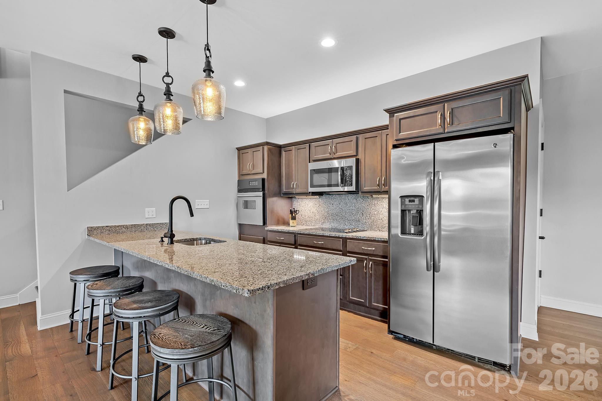64 Waterhill Way Fletcher, NC 28732 - Photo 32 of 48 a kitchen with kitchen island a counter top space a sink stainless steel appliances and cabinets