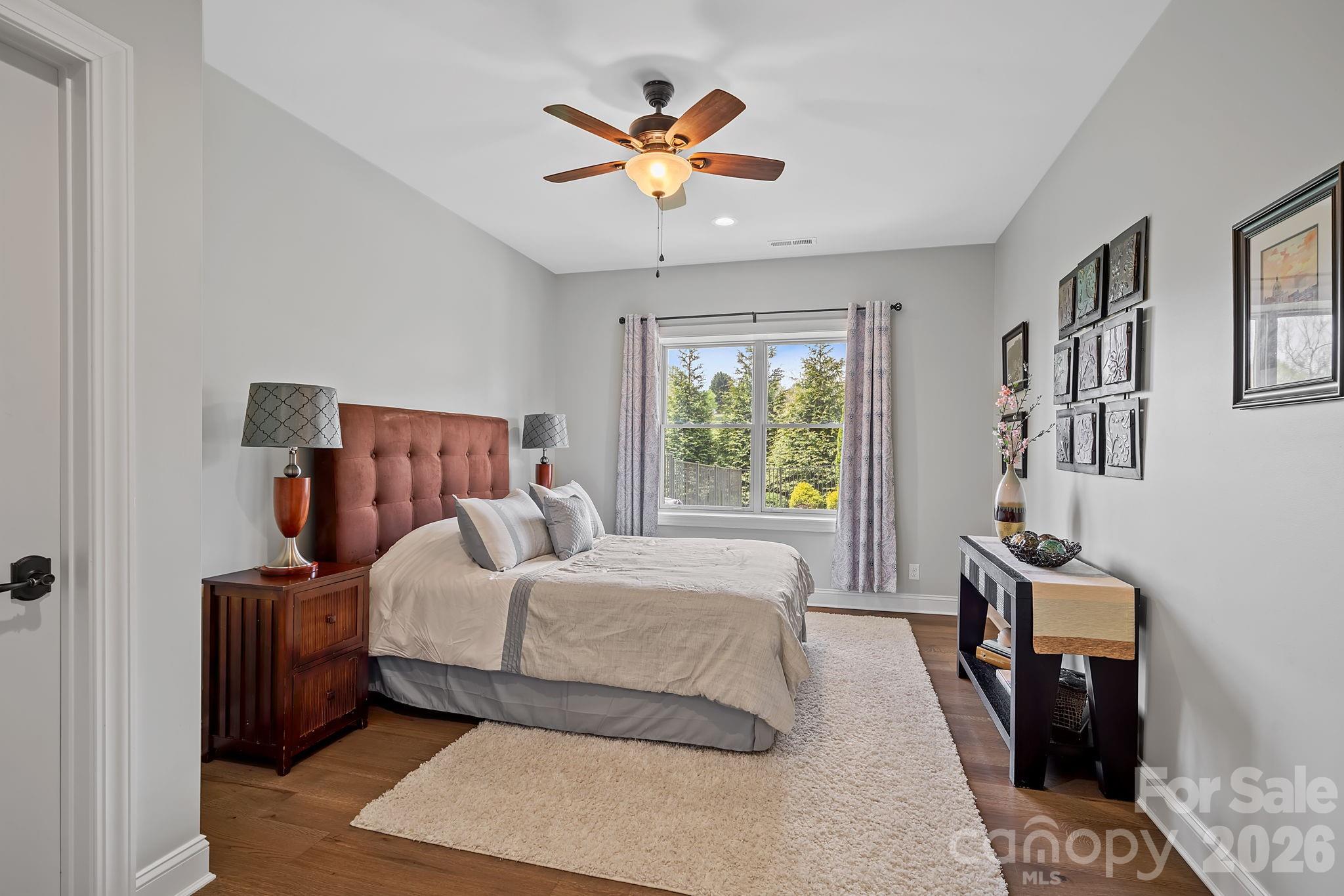 64 Waterhill Way Fletcher, NC 28732 - Photo 35 of 48 a bedroom with a large bed and a chandelier