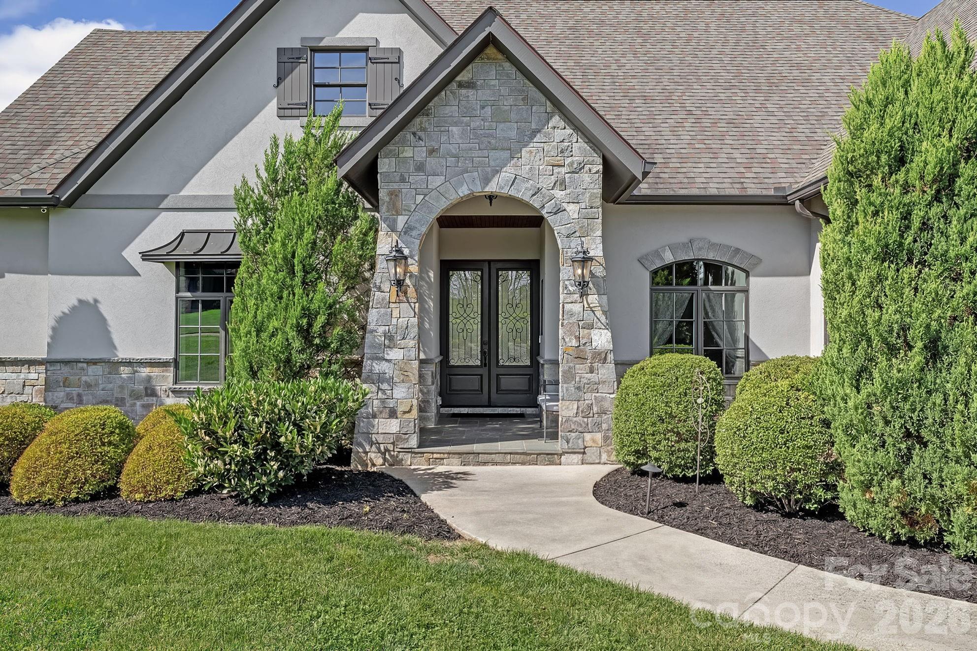 64 Waterhill Way Fletcher, NC 28732 - Photo 4 of 48 a front view of a house with a garden