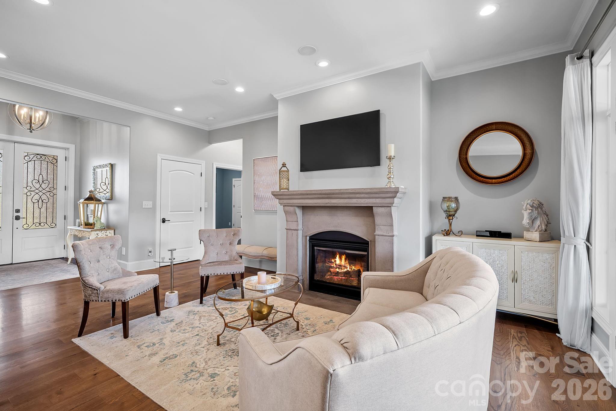 64 Waterhill Way Fletcher, NC 28732 - Photo 9 of 48 a living room with furniture a fireplace and a flat screen tv