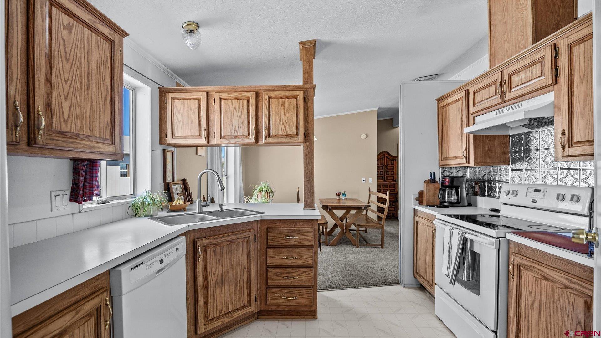 17177 Meadow Drive Cedaredge, CO 81413 - Photo 11 of 30 a kitchen with stainless steel appliances granite countertop a stove a sink and a microwave