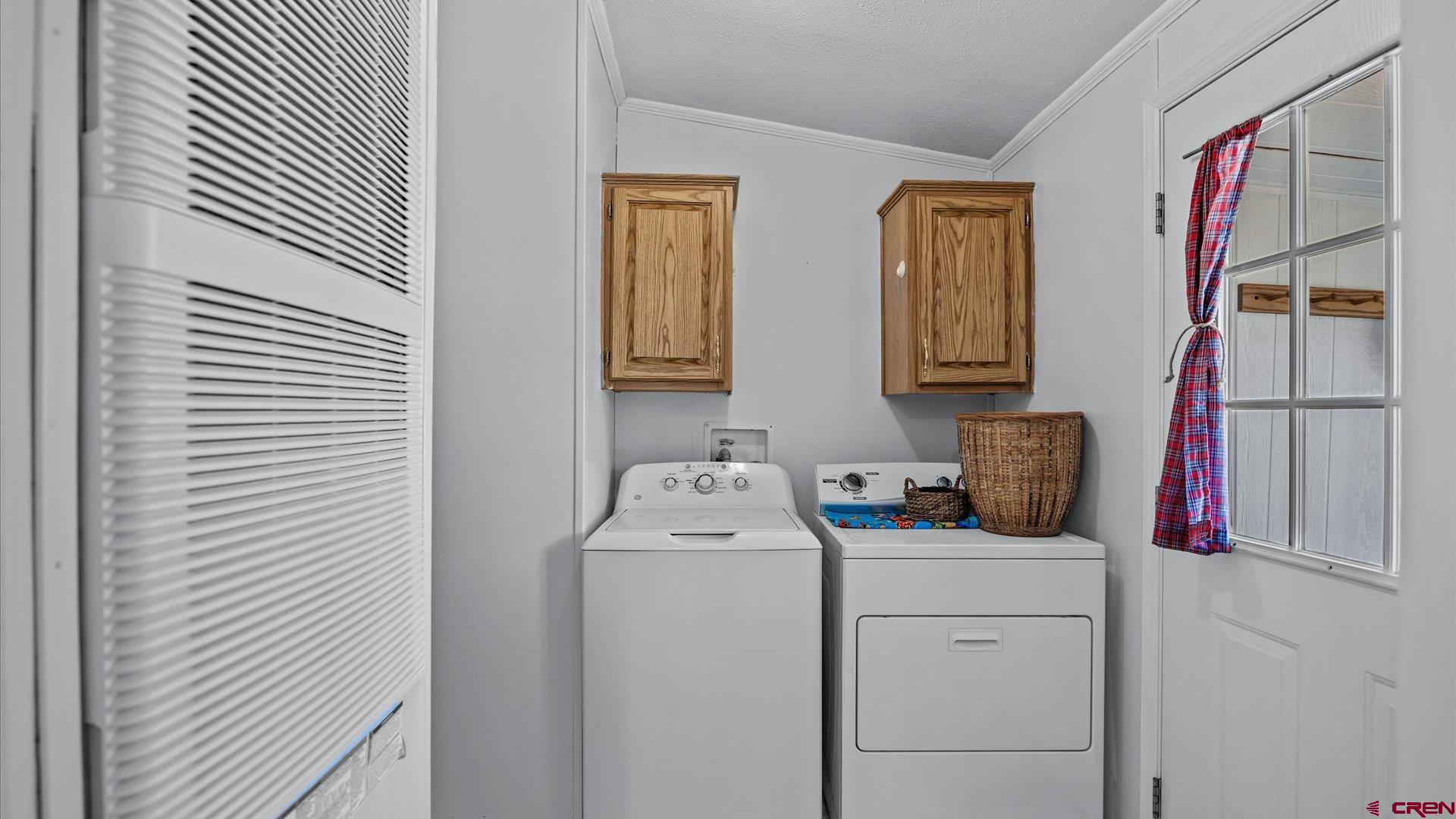 17177 Meadow Drive Cedaredge, CO 81413 - Photo 14 of 30 a utility room with dryer and washer