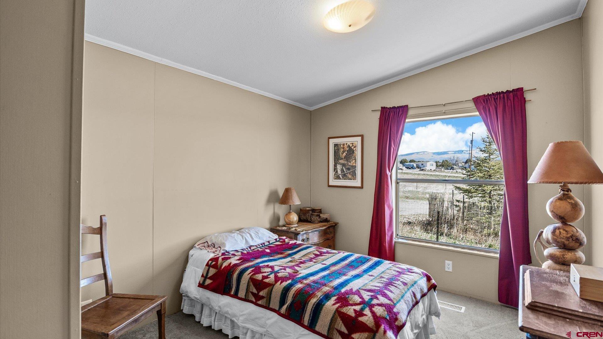 17177 Meadow Drive Cedaredge, CO 81413 - Photo 20 of 30 a bedroom with a bed and large window