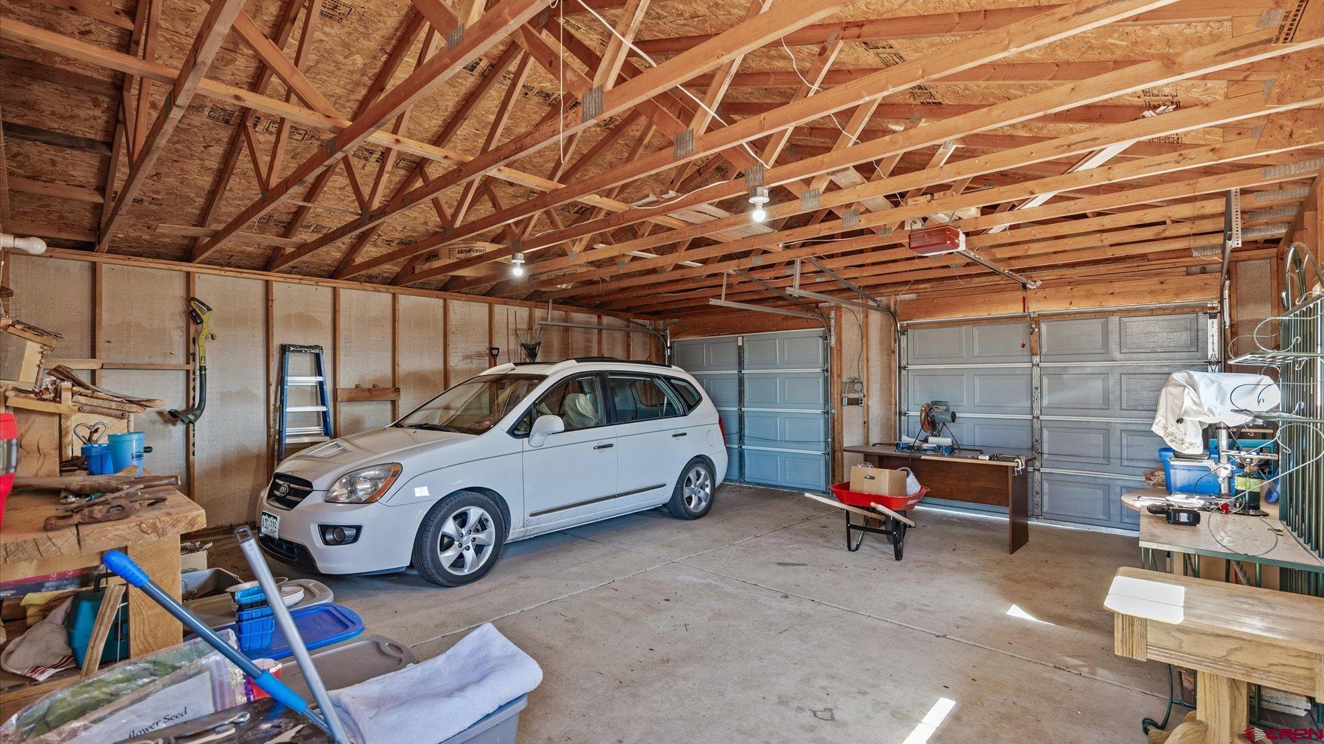 17177 Meadow Drive Cedaredge, CO 81413 - Photo 22 of 30 a car and bike parked in a garage