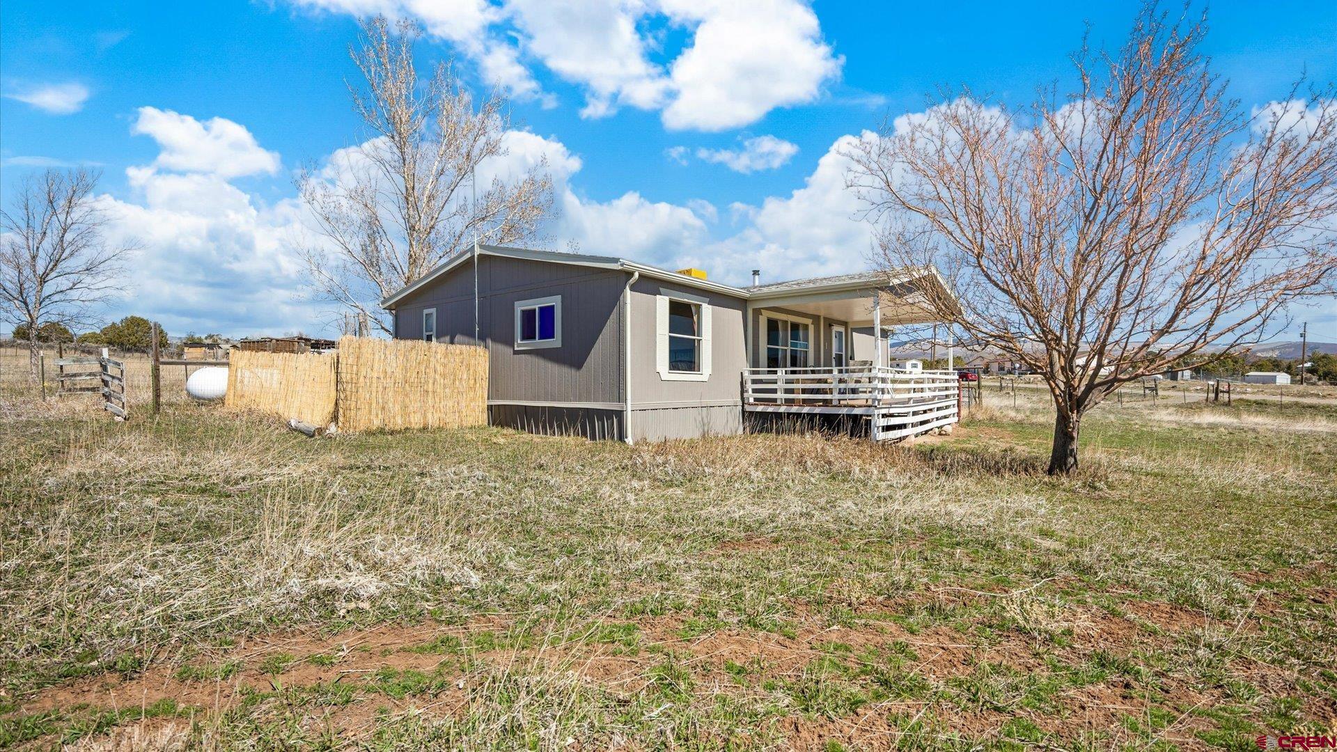 17177 Meadow Drive Cedaredge, CO 81413 - Photo 24 of 30 a front view of a house with a yard