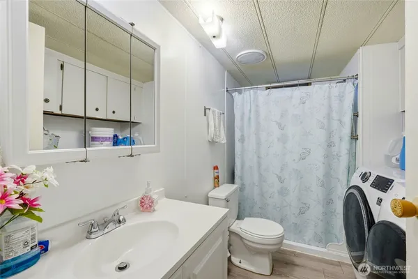 a bathroom with a sink toilet and shower