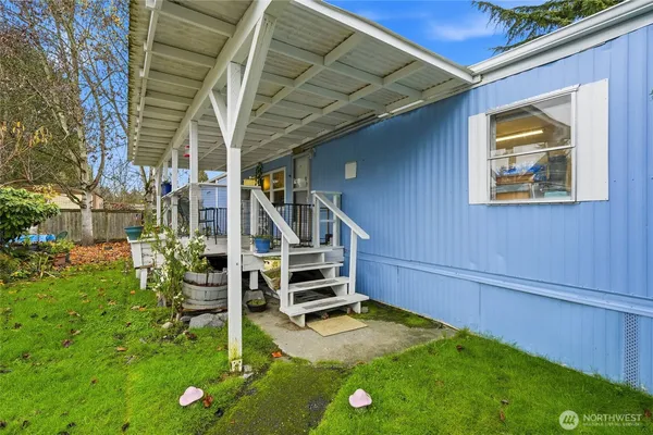a view of an house with backyard and a patio