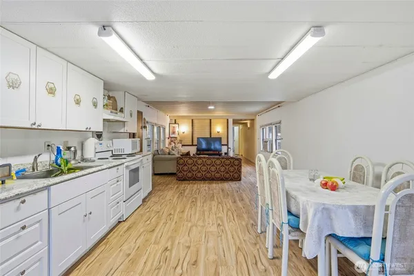 a kitchen with cabinets a sink and appliances
