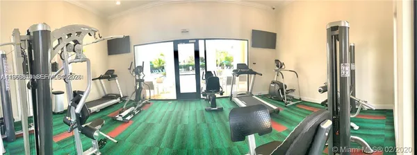 a living room filled with furniture and a floor to ceiling window