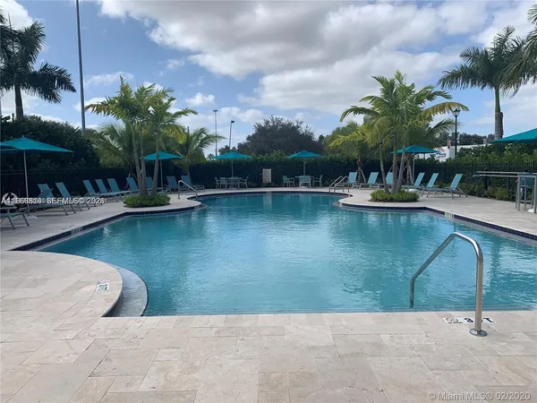 a swimming pool with outdoor seating and yard