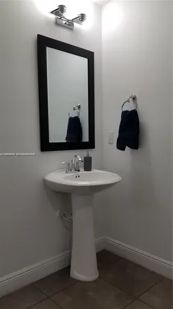 a bathroom with a sink and mirror