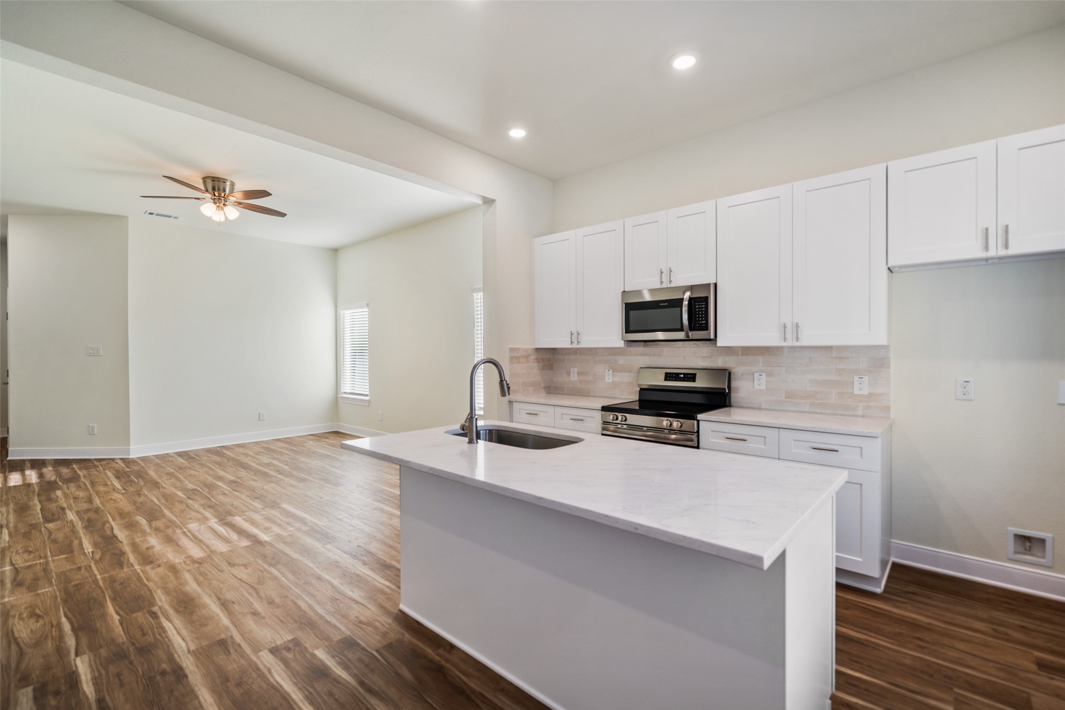 412 West Marlin Street Willis, TX 77378 - Photo 8 of 22 a kitchen with a stove a sink and a microwave