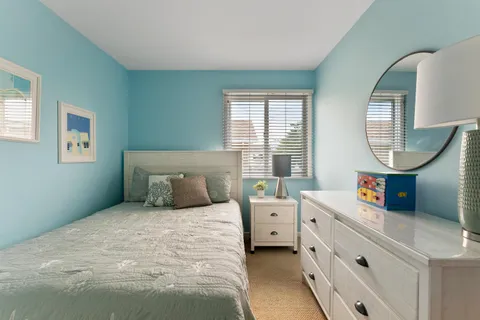 a bedroom with a bed and a mirror