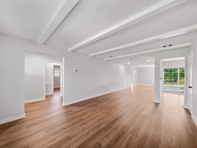 a view of kitchen and hall with wooden floor