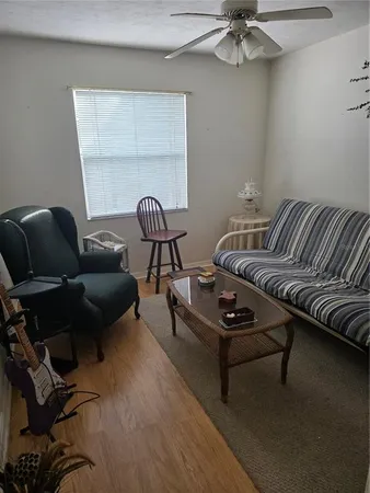 a living room with furniture and a wooden floor