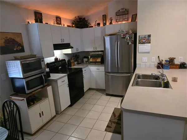 a kitchen with a sink appliances and cabinets