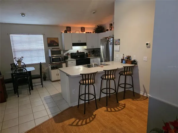 a dining room with furniture and wooden floor
