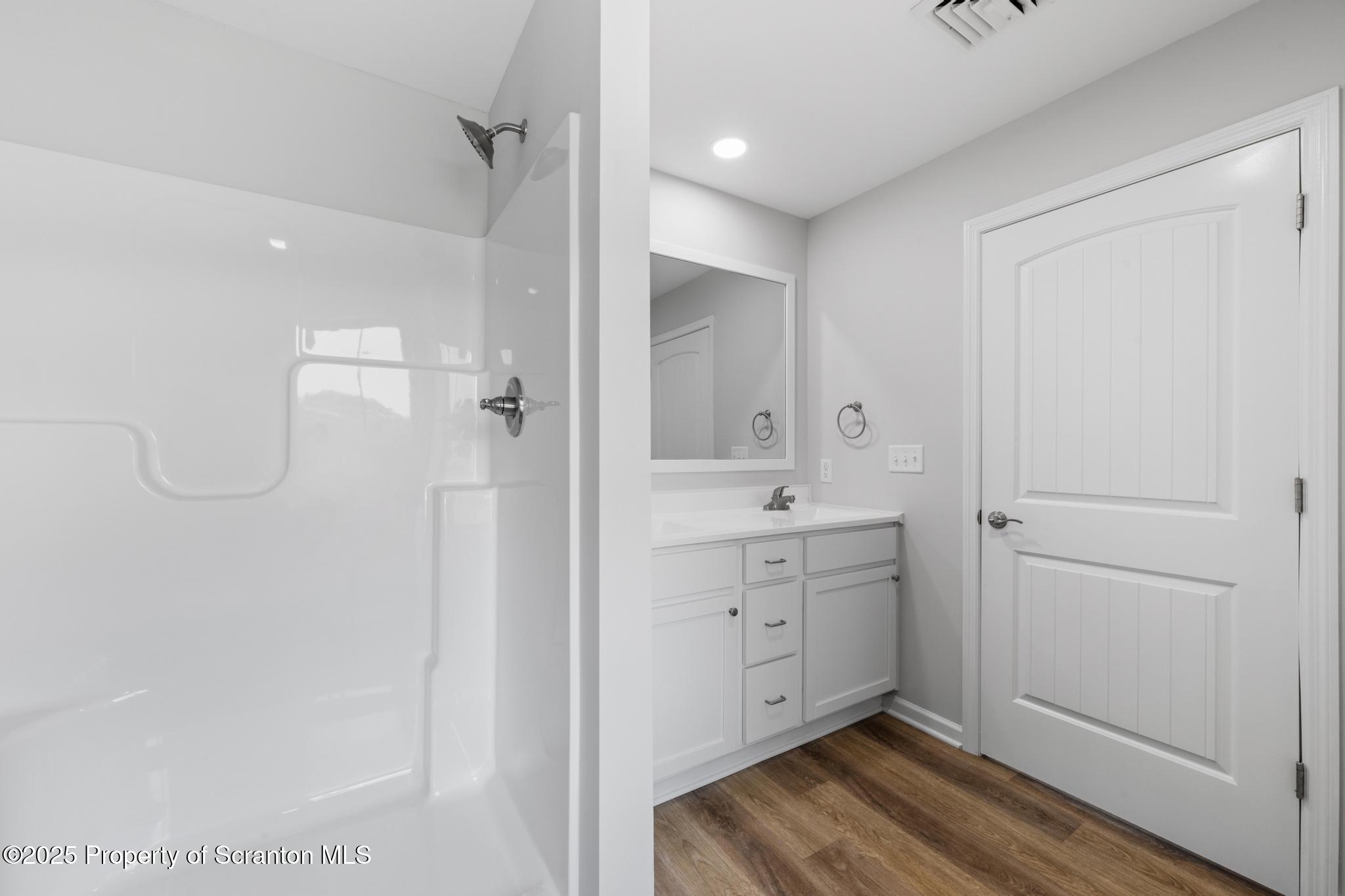 39 Zackery Way Old Forge, PA 18518 - Photo 5 of 6 a bathroom with a sink mirror and a shower
