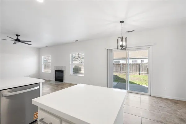 a kitchen with kitchen island a counter top space appliances and cabinets