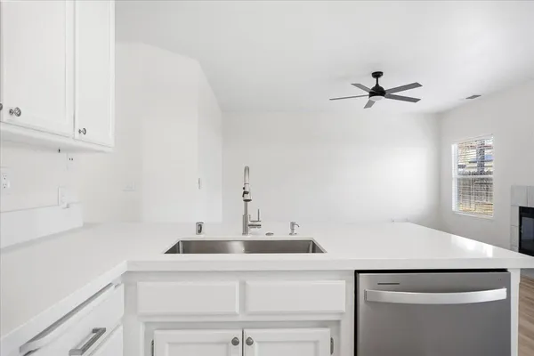 a kitchen with a sink and a refrigerator