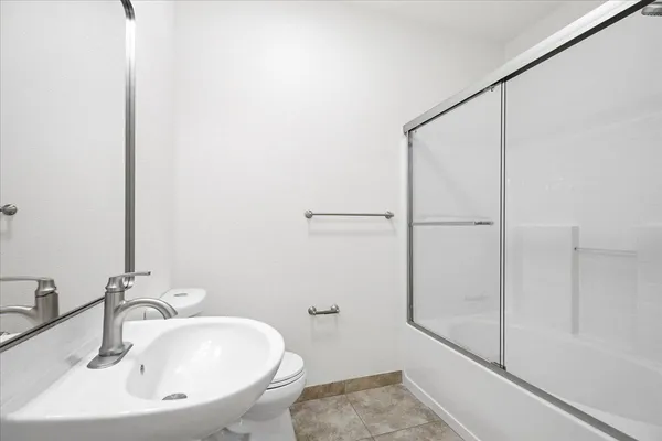 a bathroom with a sink and shower