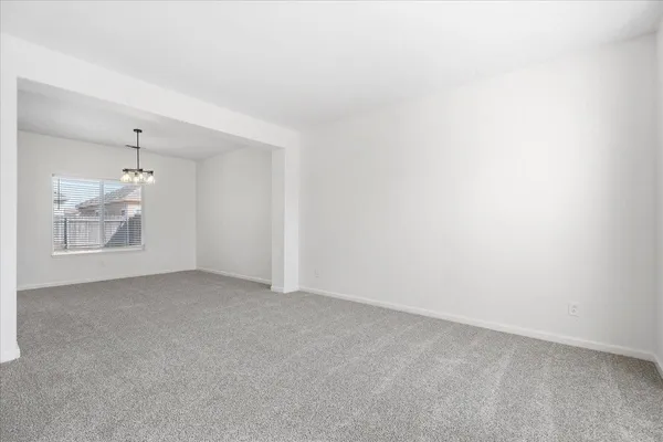 an empty room with a empty space and windows