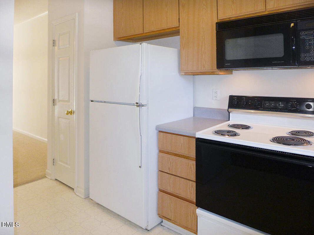 101 Rock Haven Road, Unit C301 Carrboro, NC 27510 - Photo 5 of 12 a kitchen with a sink and a microwave