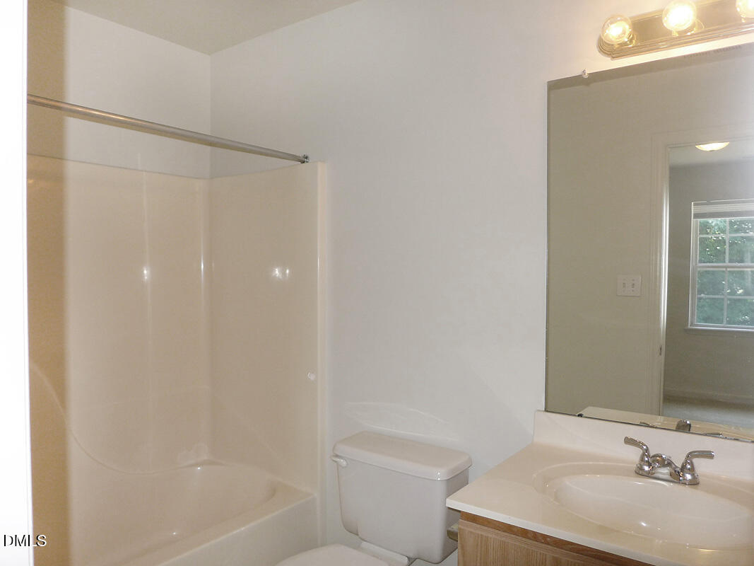 101 Rock Haven Road, Unit C301 Carrboro, NC 27510 - Photo 9 of 12 a bathroom with a bathtub shower sink vanity and toilet